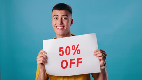 man holding a 50% off sign