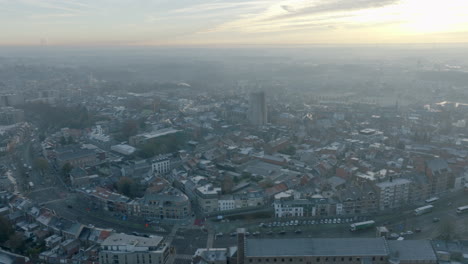 Tongeren-city-center,-high-aerial-orbit,-sunrise,-4K