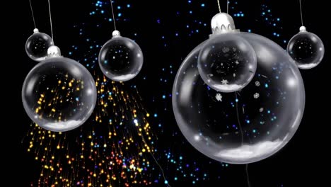 animation of christmas baubles dangling over fireworks exploding on black background