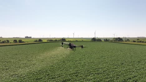 ag drone spraying chemicals on a soybean field in iowa in the summer