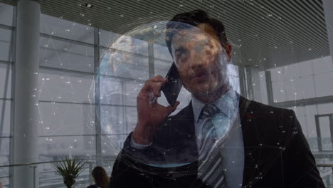 animation of connections and globe over biracial businessman using smartphone