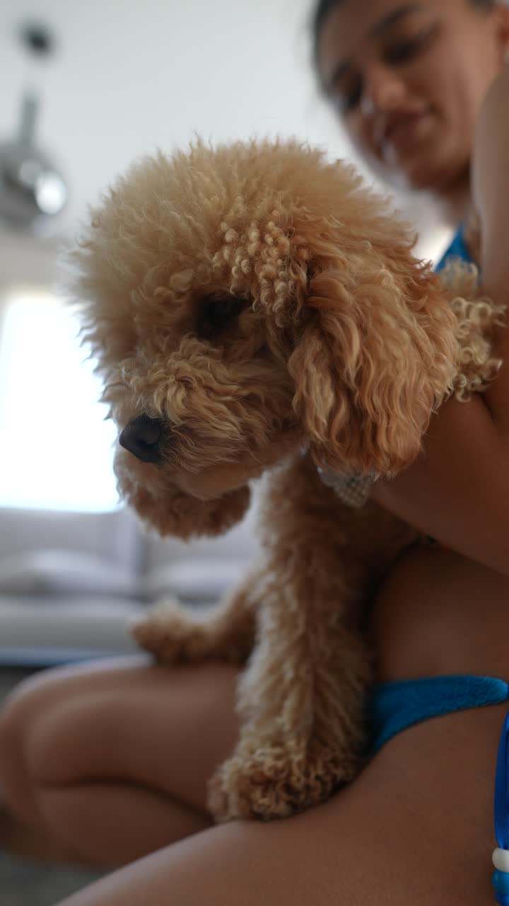 una mujer con un caniche esponjoso.