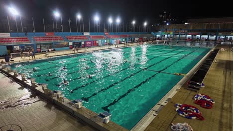 evening water polo and swimming training in the national pool complex of malta.