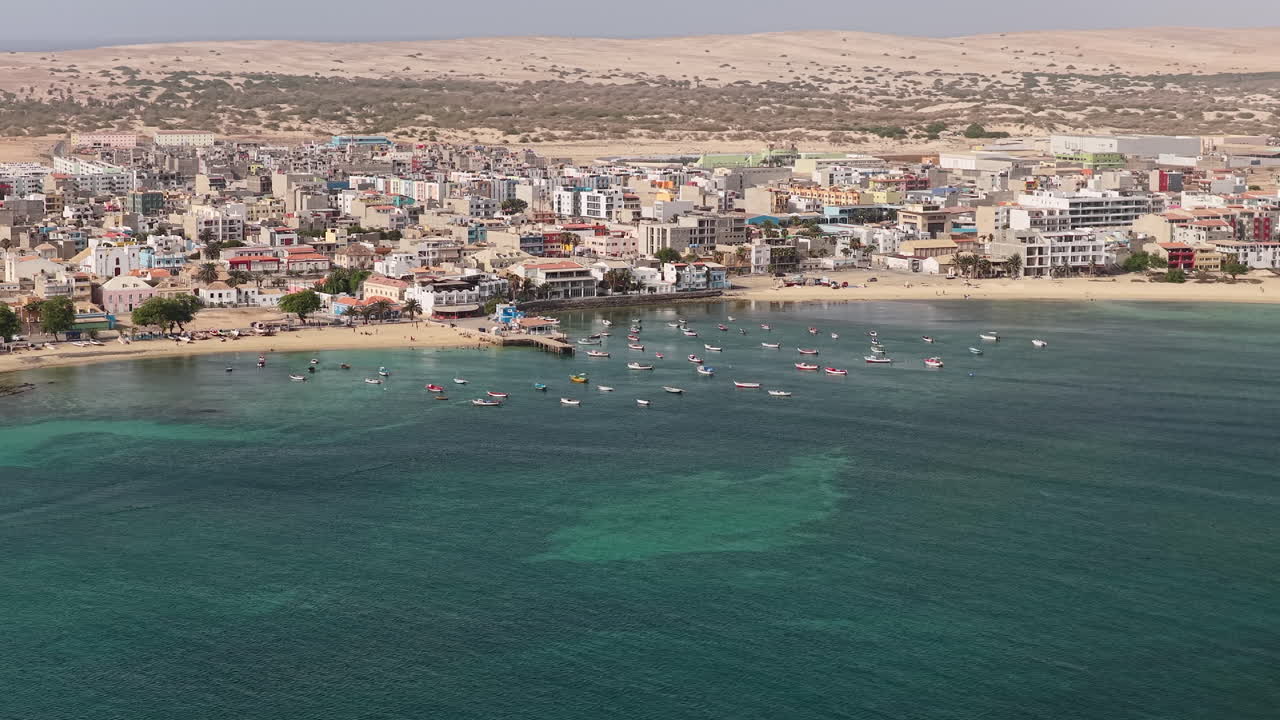 Nice panorama of the city of Sal Rei, luxury yachts and fishermen boats moored in the port, Old city with many colorful house, background the desert,Boa Vista, Cape Verde