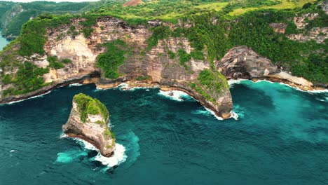 4k aerial perspective of massive limestone cliffs at nusa penida, indonesia