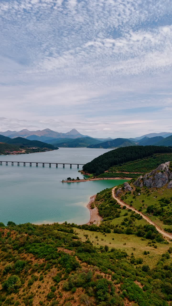 Lake with a bridge across the national park in Leon, Spain, Europe. Splendid nature view from drone footage. Vertical video.