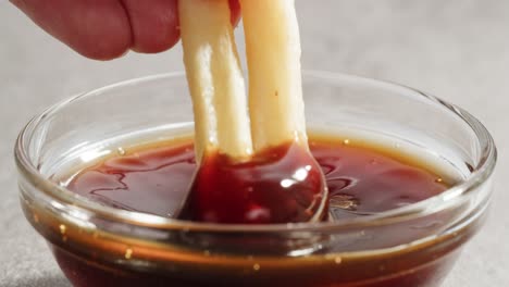crispy fries dipped in soy sauce