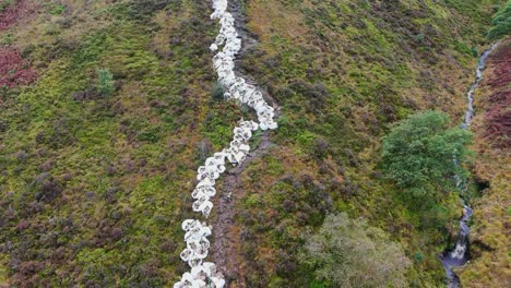 Sack-of-rocks,-rubble-lining-a-pathway-on-the-pennine-way-trail-in-the-UK