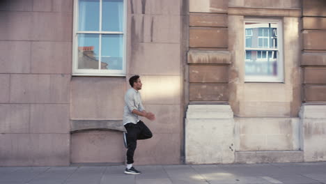 contemporary funky mixed race man street dancer dancing freestyle in the city