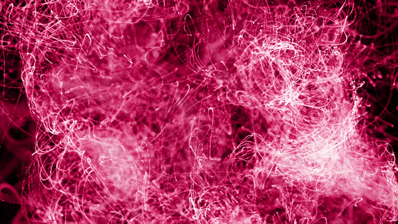 animación de rastros de luz rosada flotando sobre un fondo negro