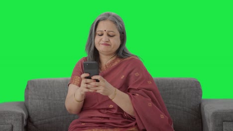 Angry-Indian-old-woman-chatting-on-phone-Green-screen