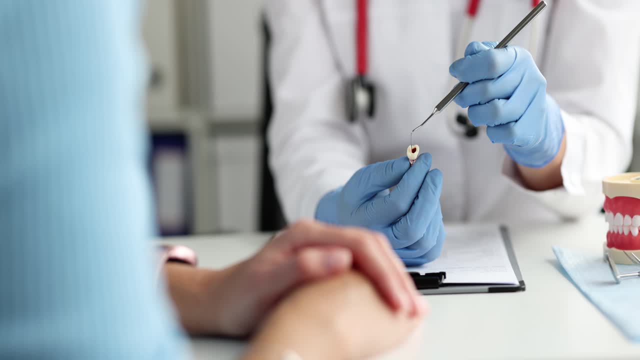 Dentist explains a tooth to a patient during a consultation