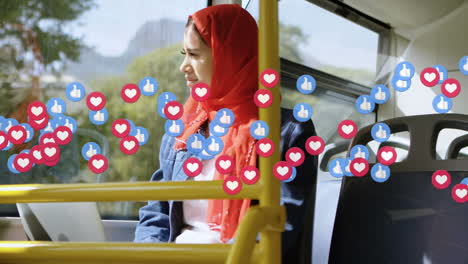 animation of falling social media icons over woman in hijab using laptop