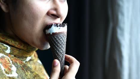 young women eating chocolate flavor ice cream