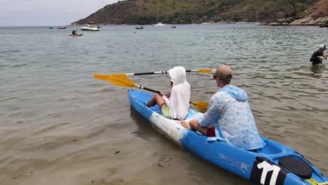 couple kayaking in a tropical bay