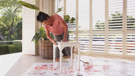 painting small table, woman focusing on diy home improvement project
