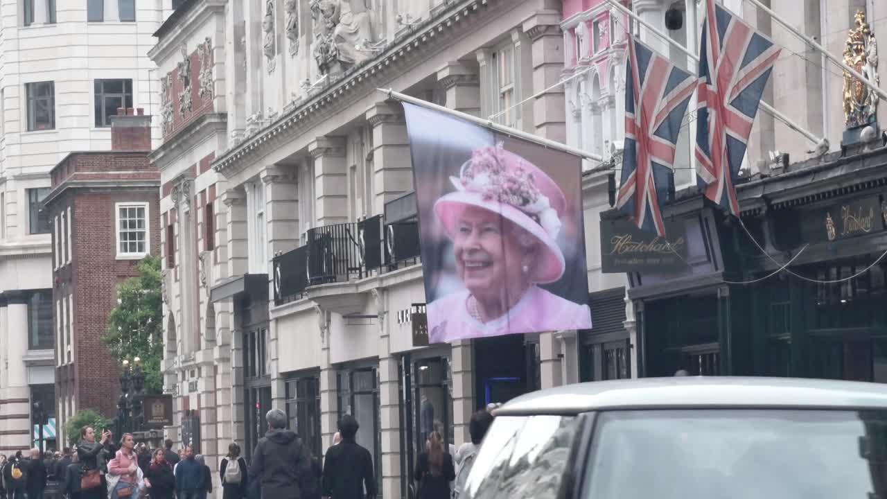 A banner of Queen Elizabeth II on a busy London street