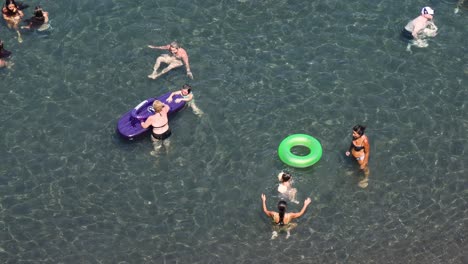 people enjoying swimming and floating in the sea