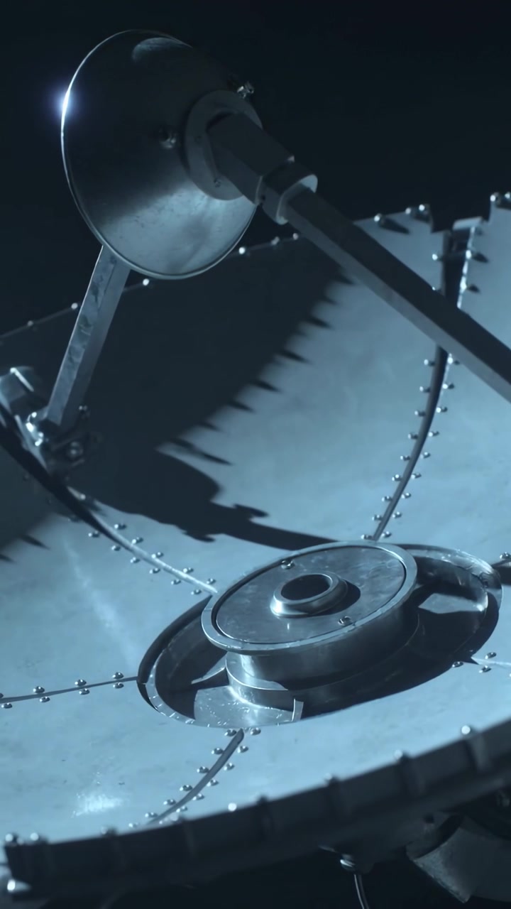 Vertical video: Panning camera revealing parabolic antenna in dark studio, showing hub, arm, rivets