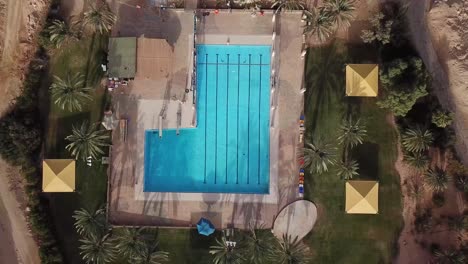 drone view of a swimming pool in the middle of the desert