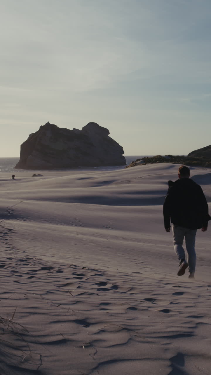 Walking Through Sand Dunes to the Ocean