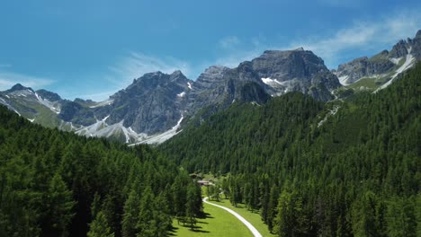 Drone-aerial-view-from-the-Schlick-2000-Ski-resort-in-summer,-located-in-the-Stubai-valley-in-Austria,-with-peaks-of-the-Schlicker-Zinnen-in-the-background