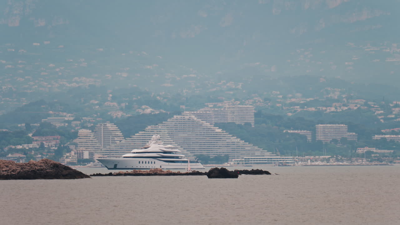 Distant view of a yacht docked near the Marina Baie des Anges in Villeneuve-Loubet, France
