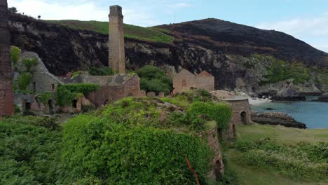 Cinematic-aerial-footgae-panning-from-right-to-left-at-the-remains-of-the-Porth-Wen-Brickworks-in-Anglesey,-North-Wales,-Europe