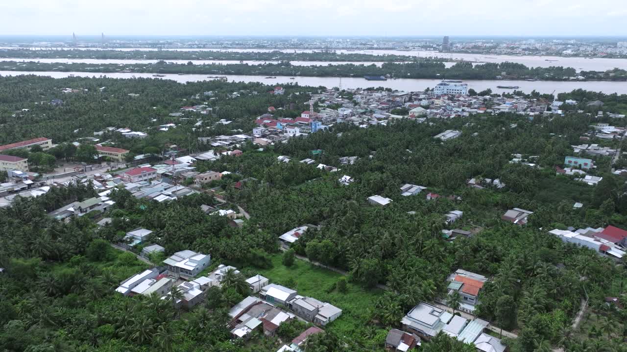Lush town in Vietnam’s Mekong Delta seen from above with dense greenery and rivers