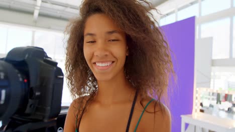 model holding camera in photo studio 4k