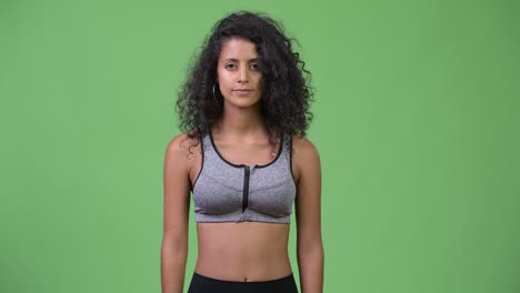 young beautiful hispanic woman with arms crossed ready for gym