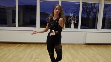 professional and passionate female dancer dances on the dance floor slow motion