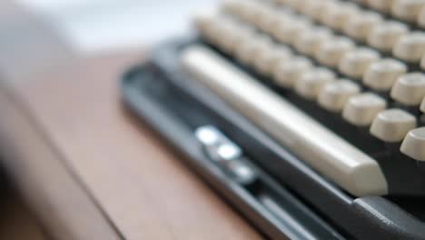 Close-up-caucasian-woman-hands-opening-portable-typewriter