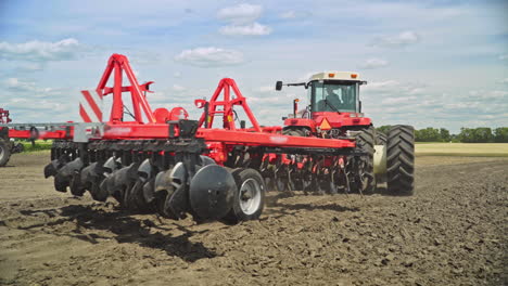 Farming-tractor-plowing-field.-Farming-machinery.-Agricultural-machinery-working