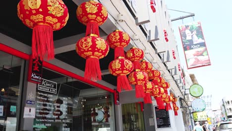 red lanterns hanging outside a building, daytime