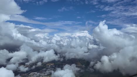an immersive view of a hypersonic speed flight through white cottony clouds under a blue sky