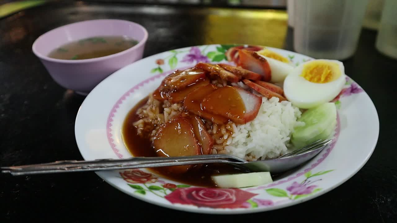 Popular Saturday Night Market Street Food in Chiang Mai, Thailand. Thai pork street food with soup and egg and rice. A lively and fun night market