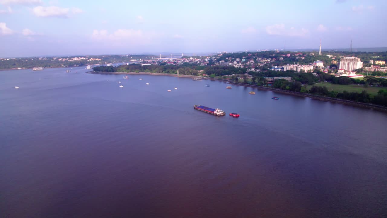 Aerial view of Panaji city with Mandovi River, ships and Atal Setu bridge at goa. day time, Dolly Up shot, drone shot, 4k