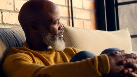 senior man relaxing in living room 4k