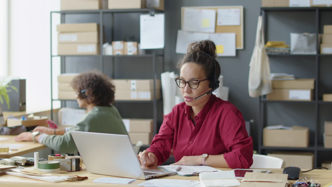 Two people working in an office call center