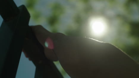 person doing pull-ups outdoors