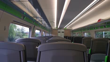 a view of an empty uk train travelling with a view from within a train carriage