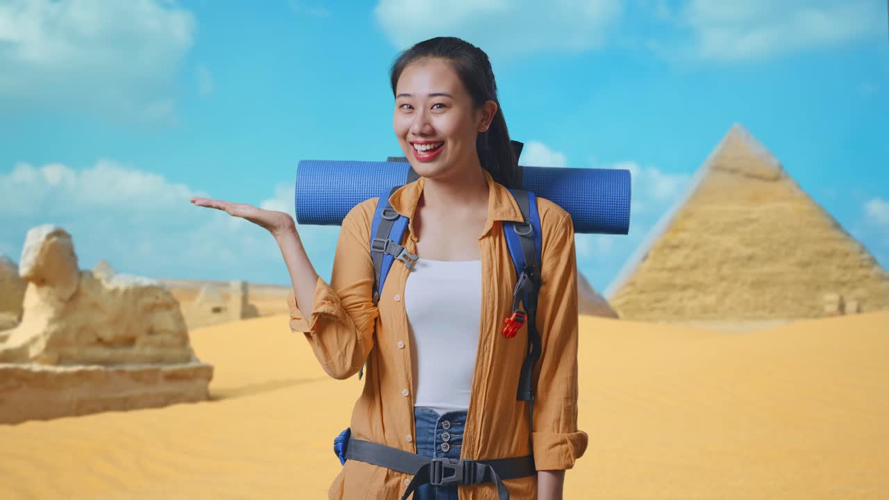 Asian Female Hiker With Mountaineering Backpack Smiling And Pointing To Side While Traveling In Pyramid Of Giza