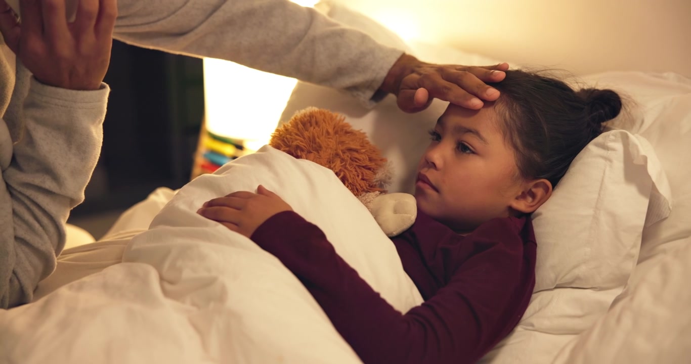 Parent Checking Fever of Sick Child in Bed at Night