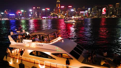 boat cruising with city lights in background