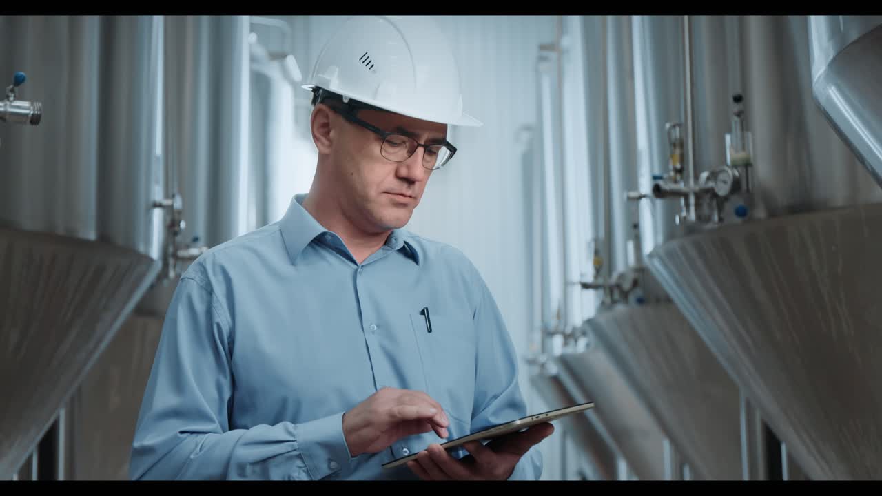 Engineer Inspecting Brewery Equipment