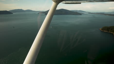 small jet plane flying over san juan islands in washington state, usa