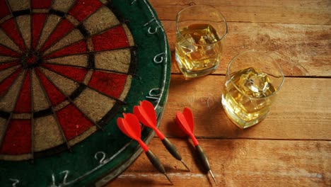 Dart-and-whisky-on-wooden-table-4k