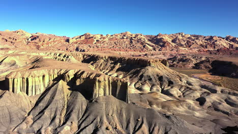 Aerial-View-of-badlands-national-park-on-a-sunny-clear-blue-sky-day,-slider-shot