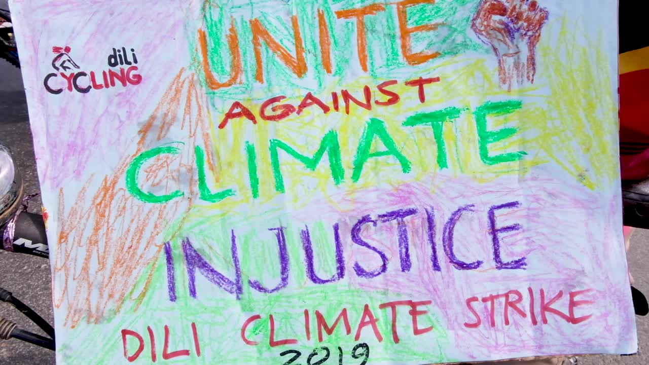 People gathering, marching and unite against climate injustice closeup. Climate change march in capital Dili, Timor Leste, Southeast Asia.